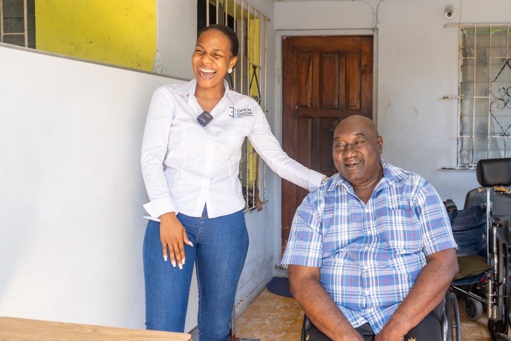 Educator extraordinaire, Mr. Dallas shares a warm moment with Terri-Karelle as she delivers a wheelchair donation from ODJF