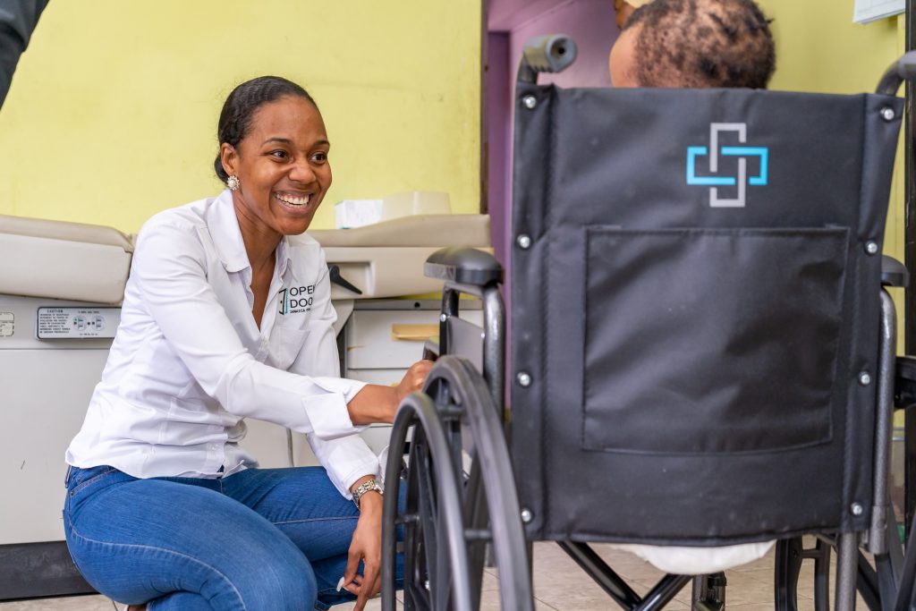 Terri-Karelle greets and smiles with a recipeint of a wheelchair donation from her foundation, The Open Door Jamaica Foundation (ODJF) 