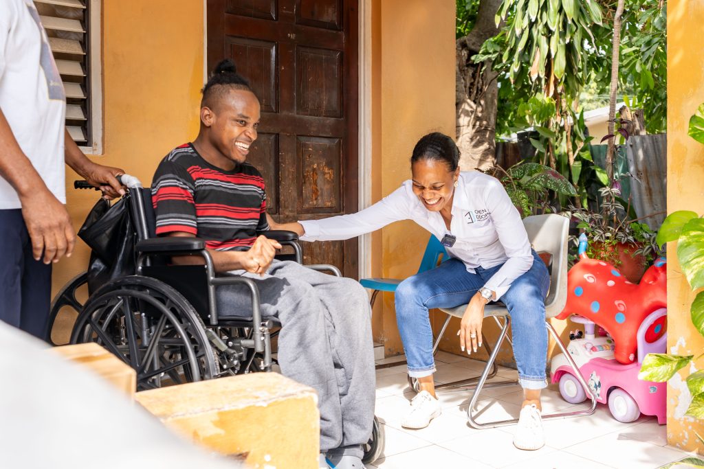 Terri-Karelle shares a joke with Santanuel, a recipient of a wheelchair donation by the Open Door Jamaica Foundation (ODJF) in collaboration with Toyota Jamaica 